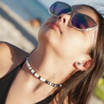 North Star black & white heishi necklace on model in sunglasses on beach