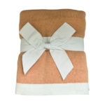 Dreamsoft Organic Cotton Travel Scarf Blush pink in color with white band shown as displayed in store, folded and tied with white cotton ribbon bow.