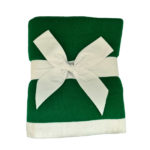 Dreamsoft Organic Cotton Travel Scarf Kelly Green in color with white band shown as displayed in store, folded and tied with white cotton ribbon bow.