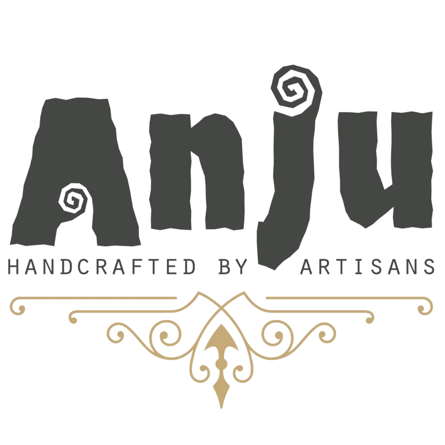 Anju Jewelry Logo of company name in black stylized block letters with swirls on A and J. with transparent background. "Handcrafted by artisans" in black block letters beneath company name. Gold pattern beneath words.