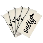 Multiple Salty Canvas Zipper Pouches fanned out and displayed on white background.