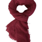 The Boho Shawl Crimson displayed in knot pattern on white background.