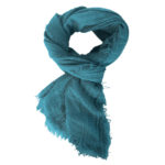 The Boho Shawl Turquoise displayed in knot pattern on white background.