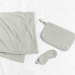 Travel Set Light Gray displayed on white background. Included is light gray blanket, eye mask, and travel pouch.