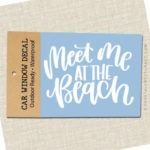 Meet Me At The Beach Vinyl Decal in packaging with brown label displayed on white background.