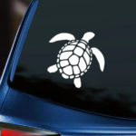 Sea Turtle Vinyl Decal white decal displayed on back window of blue car with dark tinting.