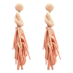 Coral Peach Beaded Knot Post Statement Earrings shown on white background. Post earring is made with coral / peach seed and bugle beads and is in a knot pattern with beaded fringe hanging down below the knot.