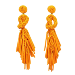 Orange Beaded Knot Post Statement Earrings shown on white background. Post earring is made with orange seed and bugle beads and is in a knot pattern with beaded fringe hanging down below the knot.