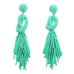 Seafoam Beaded Knot Post Statement Earrings shown on white background. Post earring is made with seafoam seed and bugle beads and is in a knot pattern with beaded fringe hanging down below the knot.