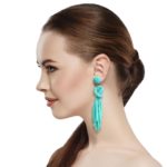 Beaded Post Statement Earrings Seafoam shown on profile of model with brown hair in ponytail. Post earring is made with seafoam seed and bugle beads and is in a knot pattern with beaded fringe hanging down below the knot.