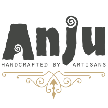 Anju Jewelry Logo of company name in black stylized block letters with swirls on A and J. with transparent background. "Handcrafted by artisans" in black block letters beneath company name. Gold pattern beneath words.